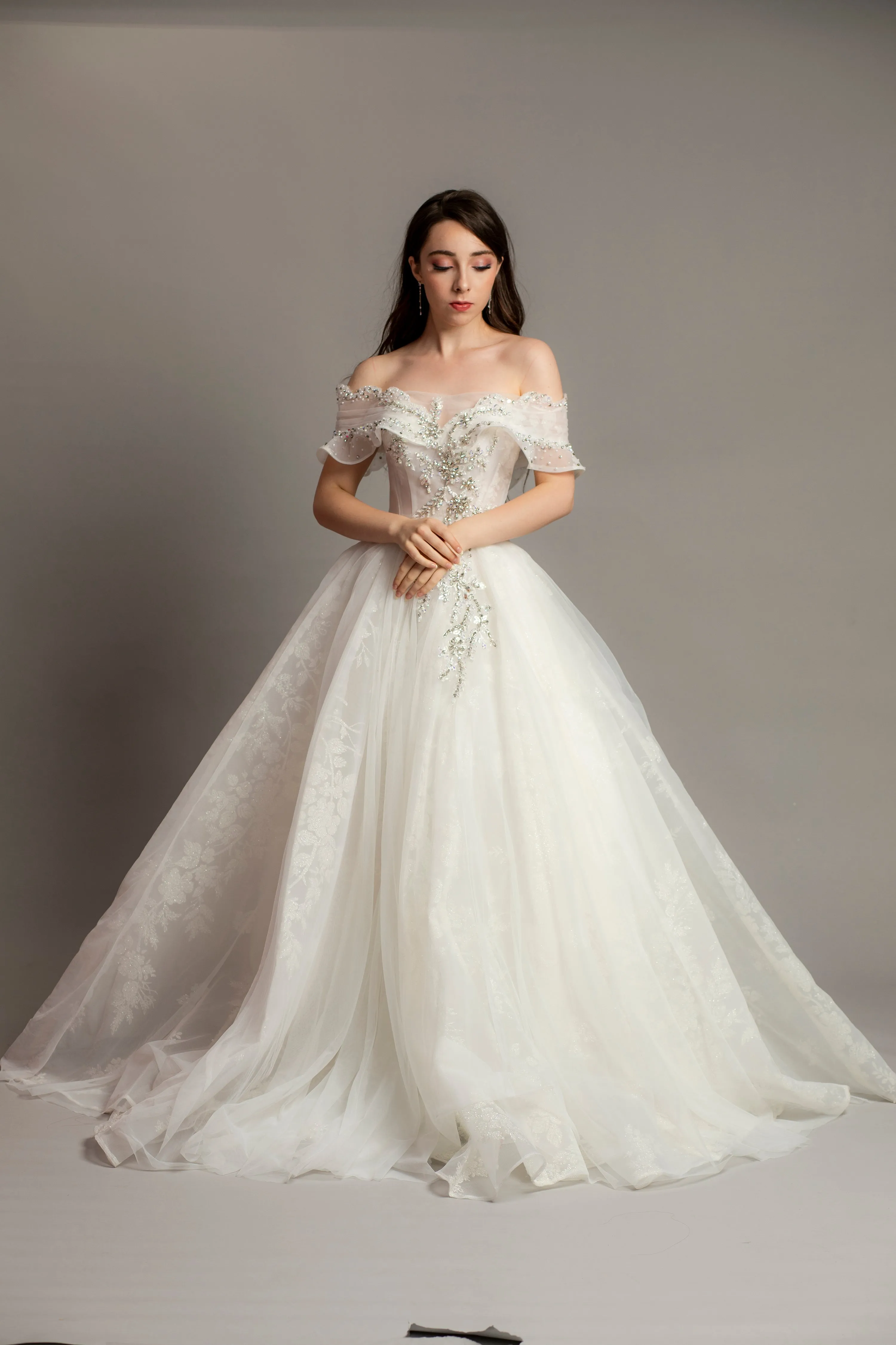 White wedding dress with asymmetrical bustier top and puffy layered skirt
